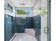 Walk-in shower with blue tile and multiple shower heads at 1676 Carroll Nw Dr, Atlanta, GA 30318