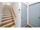 Wood staircase and hall entry with light blue doors at 1676 Carroll Nw Dr, Atlanta, GA 30318