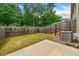 A fenced-in backyard features a patio and lush lawn at 2142 Arnage Dr, Lithonia, GA 30058