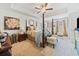 Spacious primary bedroom boasts tray ceilings, a four-poster bed, and sitting area at 2142 Arnage Dr, Lithonia, GA 30058