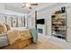 Bright primary bedroom with a fireplace, television and a built in shoe rack at 2142 Arnage Dr, Lithonia, GA 30058