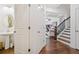 Bright foyer with staircase, powder room, and views into the adjacent living area at 2142 Arnage Dr, Lithonia, GA 30058