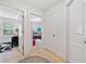 Hallway with doorways leading to a laundry room and an office space, showcasing a well-lit interior at 2142 Arnage Dr, Lithonia, GA 30058