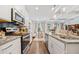 Open concept living space with modern kitchen and views to adjacent dining area at 2142 Arnage Dr, Lithonia, GA 30058