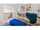 Upstairs living area features a couch, blue ottoman, staircase with black rails, and stylish decor at 2142 Arnage Dr, Lithonia, GA 30058