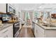 Open concept living space with modern kitchen and light-filled dining area at 2142 Arnage Dr, Lithonia, GA 30058