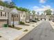 Street view of modern townhouses with attached garages and well-maintained landscaping at 2142 Arnage Dr, Lithonia, GA 30058
