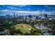 Breathtaking aerial view of Atlanta with sports fields and sprawling greenery under a bright blue sky at 222 12Th Ne St # 1806, Atlanta, GA 30309