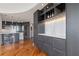 Wet bar featuring elegant marble backsplash, storage, and wine glass holder with gray cabinets at 222 12Th Ne St # 1806, Atlanta, GA 30309