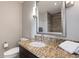 Bathroom features a granite countertop, sleek faucet, and tiled shower, offering a spa-like experience at 222 12Th Ne St # 1806, Atlanta, GA 30309