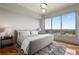 Bright bedroom boasts a large window with amazing views, wood floors, and sleek modern decor at 222 12Th Ne St # 1806, Atlanta, GA 30309