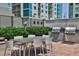 Outdoor grilling area with stainless steel grills and a dining table for alfresco meals at 222 12Th Ne St # 1806, Atlanta, GA 30309