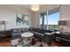 Modern living room features a comfortable gray sectional sofa and stylish decor with natural light and large window at 222 12Th Ne St # 1806, Atlanta, GA 30309
