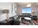 Comfortable living room featuring a gray sectional sofa, modern decor, and a large window with a view at 222 12Th Ne St # 1806, Atlanta, GA 30309