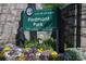 A City of Atlanta sign for Piedmont Park with flowers in the foreground at 222 12Th Ne St # 1806, Atlanta, GA 30309
