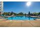 Relaxing pool area featuring lounge chairs, lush landscaping, and clear blue water, perfect for leisure and recreation at 222 12Th Ne St # 1806, Atlanta, GA 30309