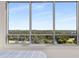 Expansive windows capturing panoramic views of lush greenery and blue skies at 222 12Th Ne St # 1806, Atlanta, GA 30309