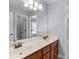 Bathroom featuring a double vanity with a large mirror and updated light fixture at 427 Oscar Ct, Mcdonough, GA 30252