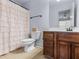 Cozy bathroom featuring a shower with a ruffled curtain and single vanity at 427 Oscar Ct, Mcdonough, GA 30252
