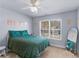 Bedroom featuring light blue walls, carpeted floors, and a large window at 427 Oscar Ct, Mcdonough, GA 30252