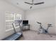 Cozy bedroom with carpet, a window providing natural light, and exercise equipment at 427 Oscar Ct, Mcdonough, GA 30252