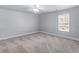 Bright bedroom featuring a ceiling fan and a window providing natural light at 427 Oscar Ct, Mcdonough, GA 30252