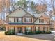 Beautiful two-story brick home featuring a covered front porch and manicured landscaping at 427 Oscar Ct, Mcdonough, GA 30252