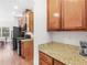 Kitchen with wood cabinets, granite counters and stainless steel appliances, hardwood floors at 427 Oscar Ct, Mcdonough, GA 30252