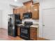 Modern kitchen with black appliances, wooden cabinets, and hardwood floors at 427 Oscar Ct, Mcdonough, GA 30252
