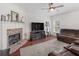 Inviting living room featuring a fireplace, plush seating, and a ceiling fan at 427 Oscar Ct, Mcdonough, GA 30252