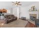 Open living area with fireplace, hardwood floors, and comfortable seating, open to kitchen at 427 Oscar Ct, Mcdonough, GA 30252