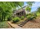 Scenic backyard view showcases lush landscaping and a multi-level deck, creating a tranquil outdoor retreat at 4754 Kelley Se Ct, Mableton, GA 30126