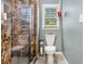 Bathroom featuring granite shower, toilet, decorative plants and wall mirror at 4754 Kelley Se Ct, Mableton, GA 30126
