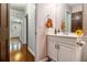 Hall bathroom with white vanity, decorative mirror, and views of the hallway at 4754 Kelley Se Ct, Mableton, GA 30126