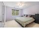 Bedroom with carpet, light purple walls, a large bed and a dark dresser at 4754 Kelley Se Ct, Mableton, GA 30126