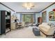 Comfortable bedroom featuring carpet, a ceiling fan, and a window with wooded view at 4754 Kelley Se Ct, Mableton, GA 30126