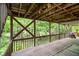 Covered deck area offering shade and views of the surrounding yard and foliage, perfect for outdoor enjoyment at 4754 Kelley Se Ct, Mableton, GA 30126