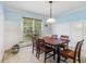 Bright dining room featuring traditional wainscoting, light blue walls, carpet and large windows at 4754 Kelley Se Ct, Mableton, GA 30126