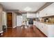 Bright kitchen features white cabinets, stainless steel appliances and granite countertops at 4754 Kelley Se Ct, Mableton, GA 30126