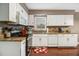 Bright kitchen featuring white cabinets, granite countertops, stainless steel appliances, and hardwood floors at 4754 Kelley Se Ct, Mableton, GA 30126