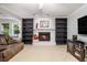 Comfortable living room with a fireplace flanked by bookcases and filled with natural light at 4754 Kelley Se Ct, Mableton, GA 30126