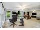 Large living space with multiple areas and views of the outdoors through large windows at 4754 Kelley Se Ct, Mableton, GA 30126