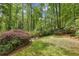 The backyard includes a nicely maintained lawn and is surrounded by mature trees and lush landscaping at 1050 Mountain Creek Trl, Atlanta, GA 30328