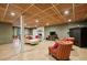Spacious finished basement with tiled floor, wood ceiling, and cozy seating around a stone fireplace at 1050 Mountain Creek Trl, Atlanta, GA 30328