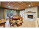 Basement dining area with fireplace, tile flooring, and access to the outdoors through glass doors at 1050 Mountain Creek Trl, Atlanta, GA 30328