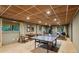 Finished basement with tiled floor perfect as a recreational area with exercise equipment and a ping pong table at 1050 Mountain Creek Trl, Atlanta, GA 30328