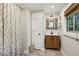 Cozy bathroom featuring a shower with curtain, wooden vanity and mirror and tiled floor at 1050 Mountain Creek Trl, Atlanta, GA 30328