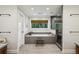 Modern bathroom with a soaking tub, walk-in shower, grey tile, and view to the exterior at 1050 Mountain Creek Trl, Atlanta, GA 30328
