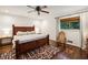 Cozy bedroom with a dark wood bed frame, ceiling fan and plenty of natural light at 1050 Mountain Creek Trl, Atlanta, GA 30328