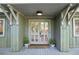 Charming entrance with double doors, light fixture, and potted plants at 1050 Mountain Creek Trl, Atlanta, GA 30328